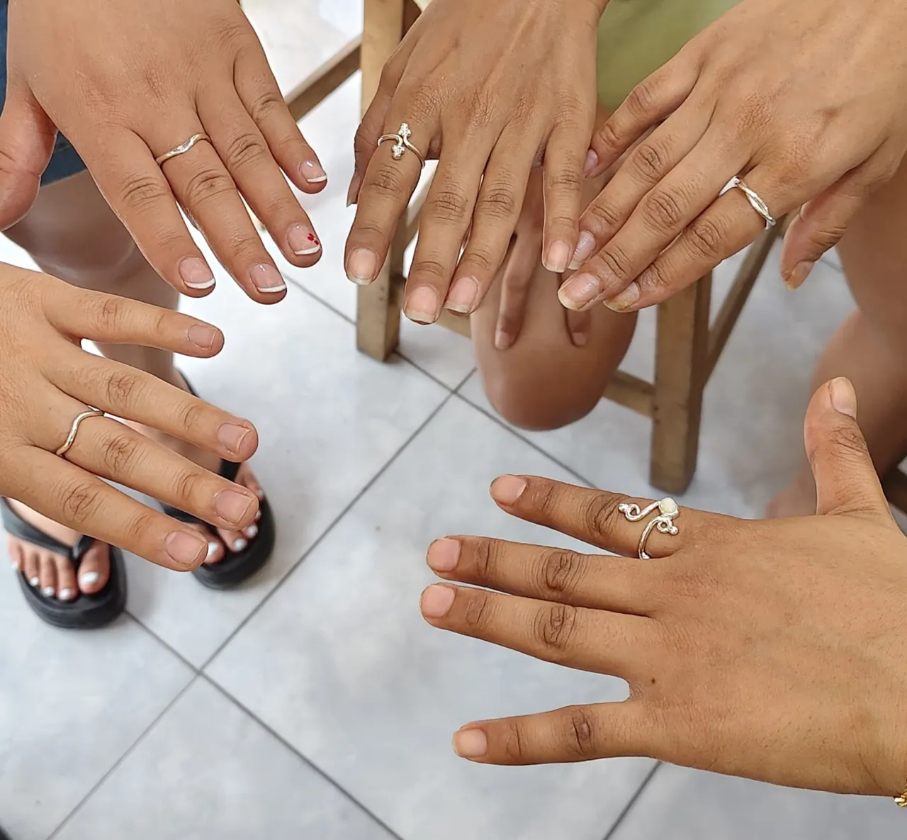 Silver jewelry workshop participants showing handcrafted silver rings